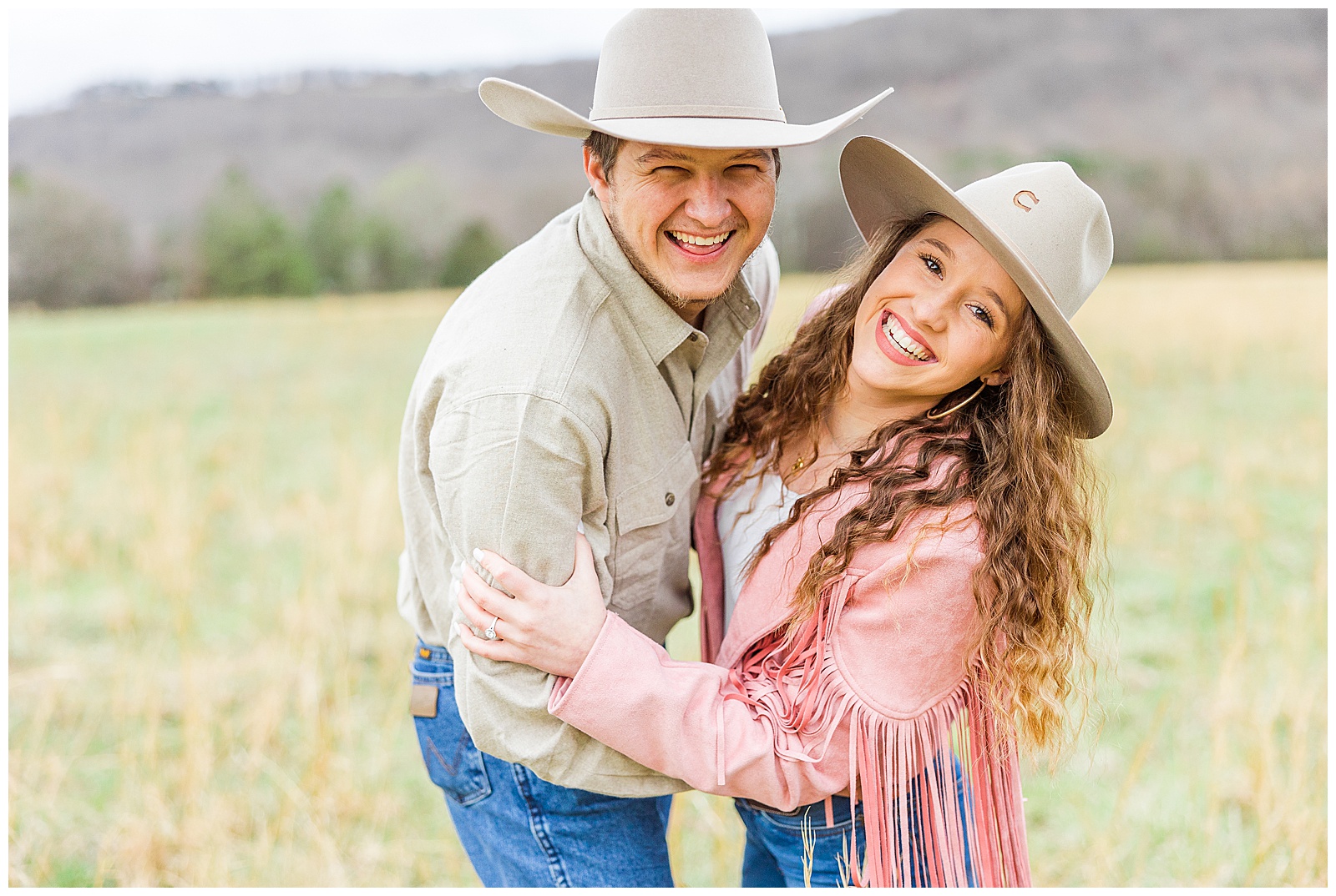 male and female smiling with cowboy hats