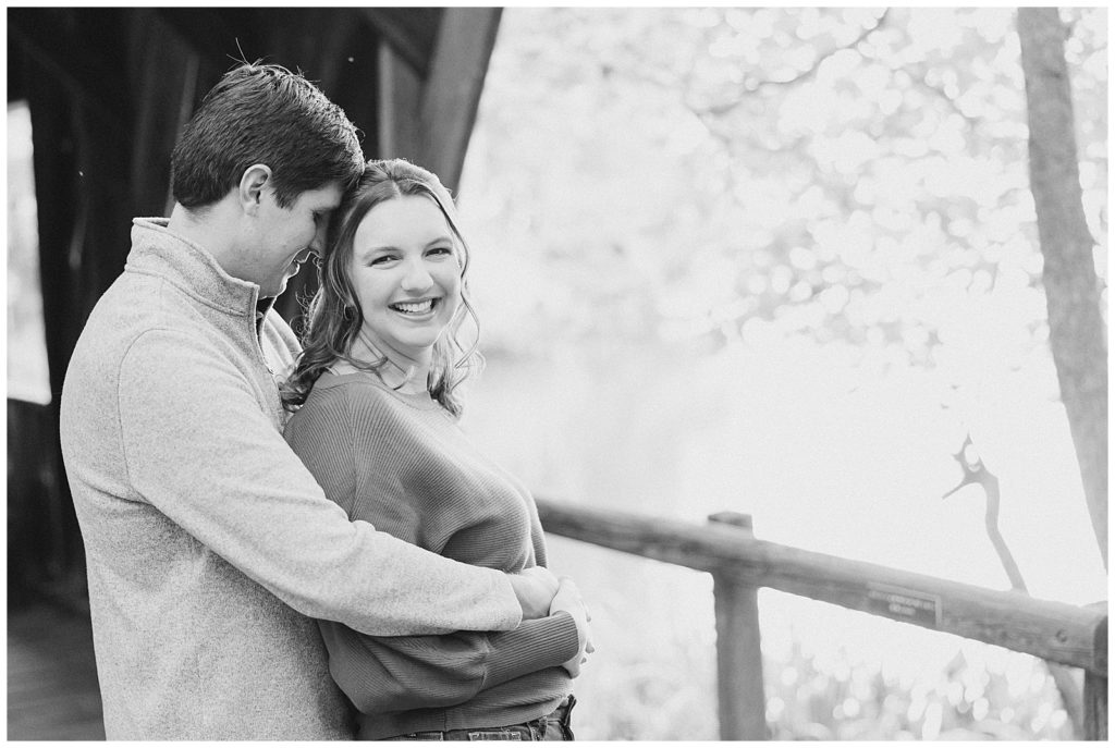 couple by covered bridge