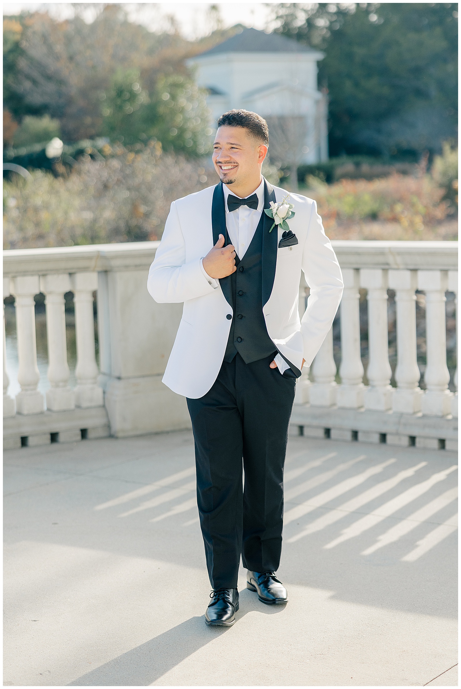 groom portrait shot white suit jacket